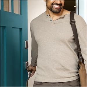 Man unlocking door lock with key